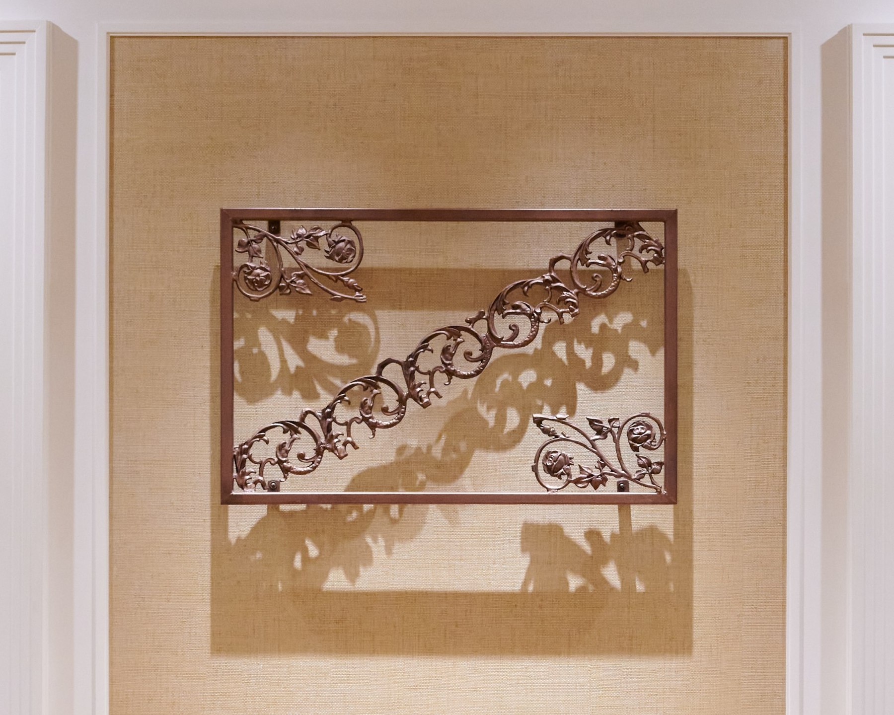 Front view of rectangular ironwork with diagonal ornamental bands