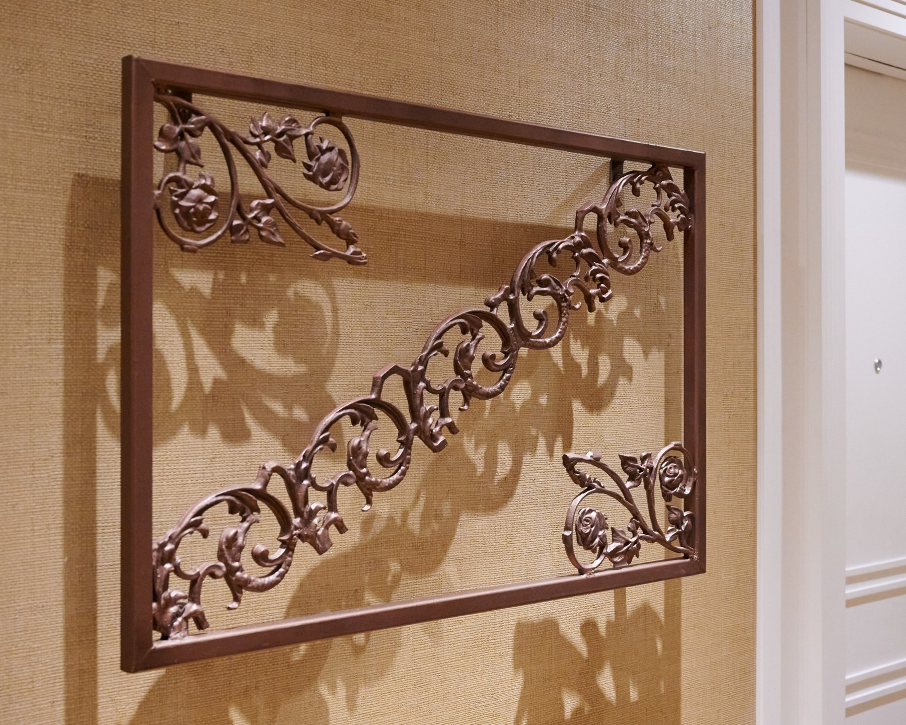Close angled view of ornamental ironwork and cast shadows