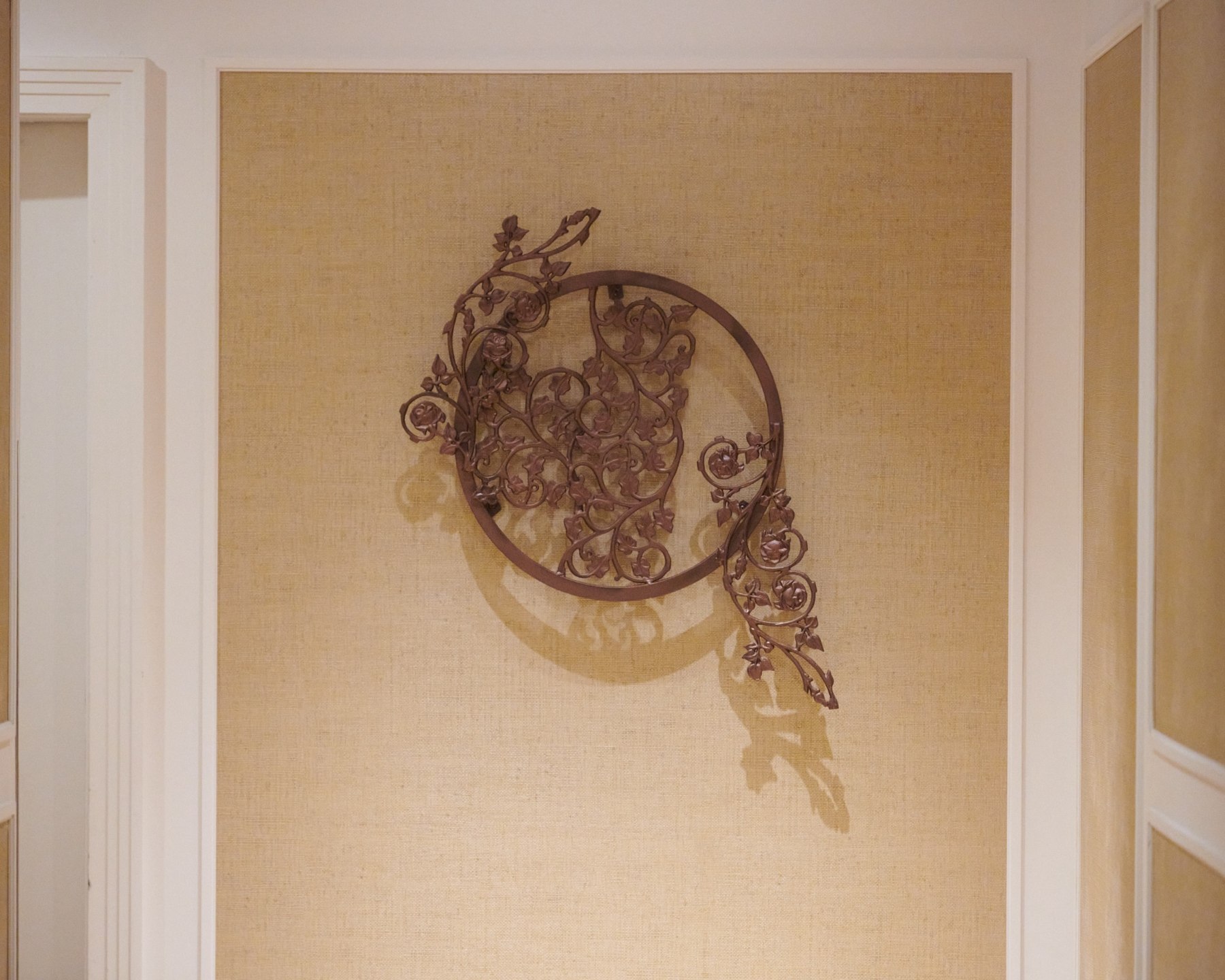 An installed circular ironwork composition with a diagonal ornamental band